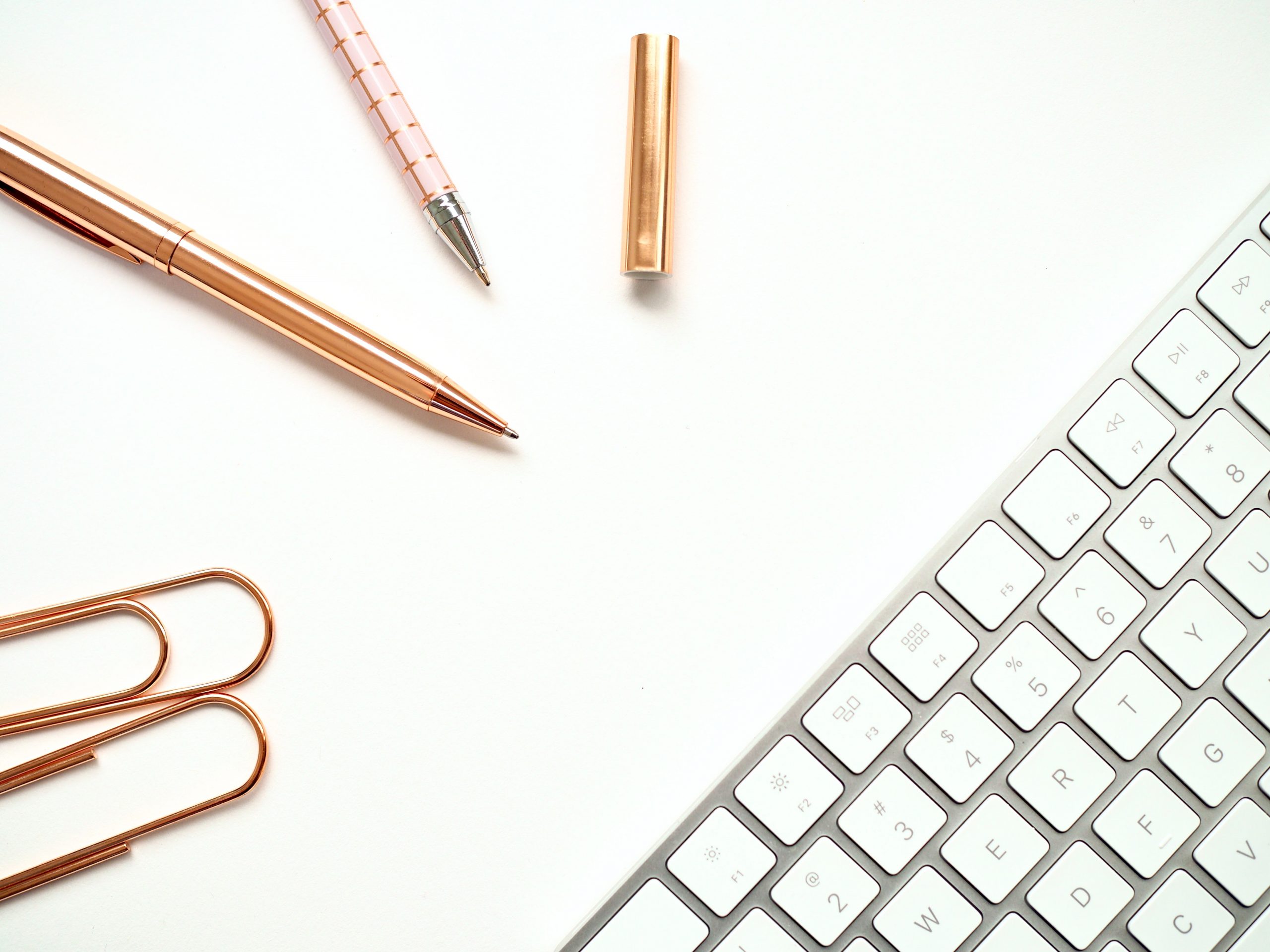 pens-near-keyboard-and-paper-clips-1558690